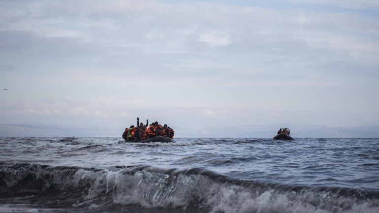 Migrants and refugees onboard a dinghy approach a coast after crossing a part of the Aegean sea from the Turkish coast to the northeastern Greek island of Lesbos, on Wednesday, Dec. 16, 2015. Greek authorities say two people have drowned and 83 others have been rescued after a wooden boat crammed with refugees sank in the Aegean Sea off the eastern Greek island of Lesbos. (AP Photo/Santi Palacios)