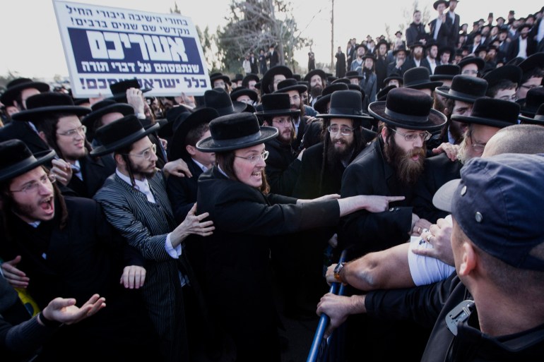 d98ad8b3d98a-1710268542 Ultra-Orthodox Jewish men rally following the arrest of a young man who refused to serve in the Israeli the army, as they protest outside the Atlit military prison near the northenr coastal city of Haifa, on December 9, 2013. The Ultra-Orthodox community places great value on religious scholarship and believe that Torah study plays a role in protecting the Jewish people. Following Israel's establishment in 1948, they were allowed to forego military service in favor of religious studies. Today their are some 3000 Ultra-Orthodox men serving in the Netzach Yehuda, an all-Haredi (Ultra-Orthodox community known as Haredim) battalion, some of whom are going against the wishes of many in their community. AFP PHOTO / JACK GUEZ (Photo by JACK GUEZ / AFP)