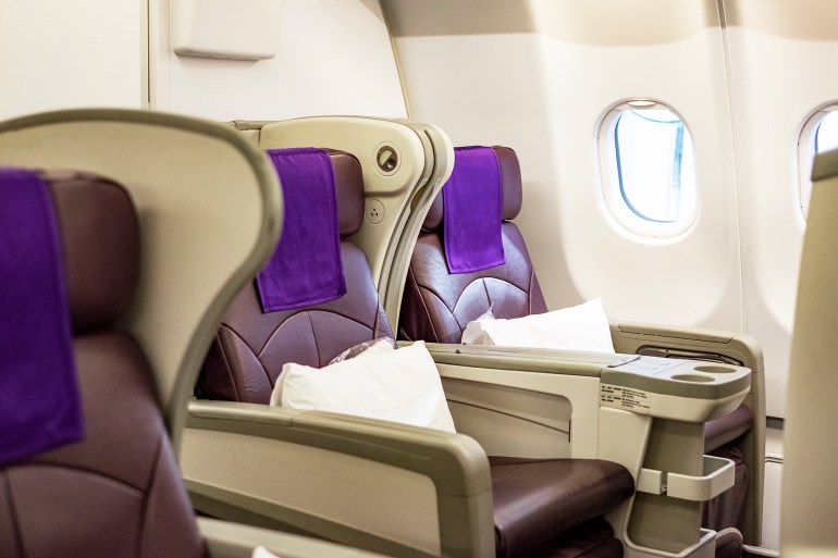 gettyimages-1394348622-1728072634 Business class seat on an airplane.