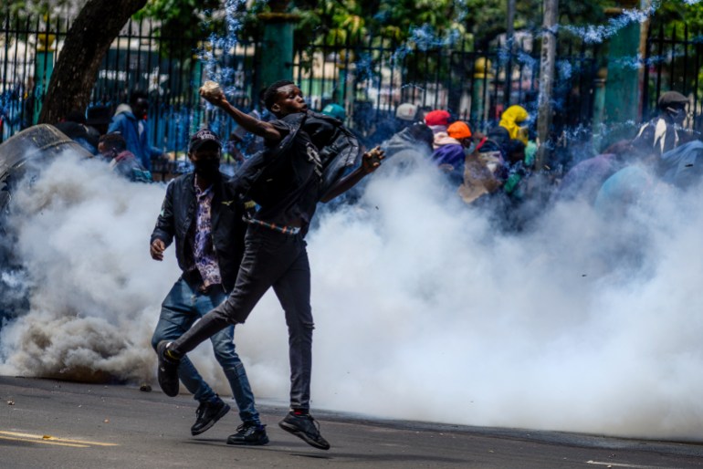 gettyimages-2158704229-1719407479 NAIROBI, KENYA - JUNE 25: People clash with police during a protest against the tax hikes in planned 'Finance Bill 2024' as they march to the parliament building in Nairobi, Kenya on June 25, 2024. (Photo by Gerald Anderson/Anadolu via Getty Images)