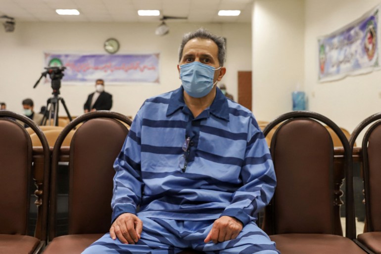57413d98a-1730827954 Jamshid Sharmahd, who is accused by the Iranian government of being a leader of the US-based "Tondar terrorist group" behind a deadly attack in Iran in 2008, attends the first hearing of his trial in the capital Tehran on February 6, 2022. Sharmahd is accused of corruption on earth by planning and directing terrorist acts, including the bombing of a mosque in Shiraz (south) on April 12, 2008, which killed 14 people and injured approximately 300 others," Mizan website reported. The accusation of spreading "corruption on earth" is one of the most severe charges in the Islamic republic and can lead to a verdict of death penalty for the accused. (Photo by Koosha MAHSHID FALAHI / MIZAN NEWS AGENCY / AFP)