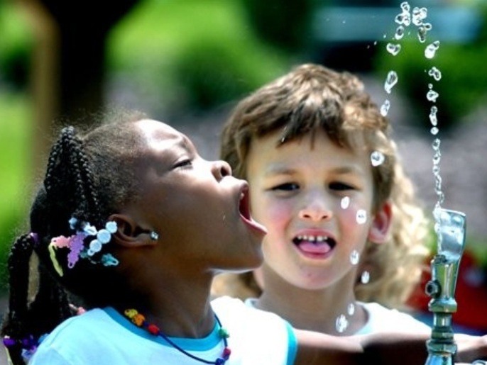 6ffe2c81-86e8-4d28-bbb9-14473276b71e FILE - In this June 3, 2008 file photo, Liberty Valley Elementary School, Danville, Pa., kindergarten student Tianna Swisher attempts to drink from the water fountain at Montour Preserve, near Washingtonville, Pa., during the school's outdoor field trip. Fluoride in drinking water, credited with dramatically cutting cavities and tooth decay, may now be too much of a good thing. It's causing spots on some kids' teeth. A reported increase in the spotting problem is one reason the federal government will announce Friday, Jan. 7, 2011, it plans to lower the recommended limit for fluoride in water supplies, the first such change in nearly 50 years.