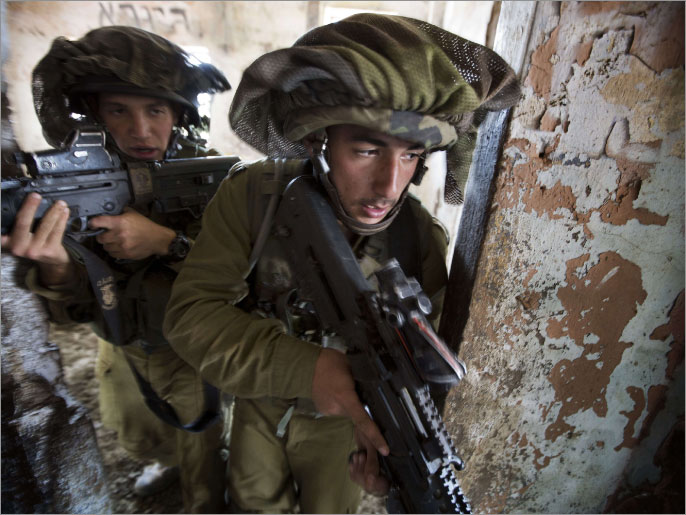 82a4f684-4428-4ddc-8a8c-24021f86385c Israeli infantry soldiers of the Golani brigade take part in exercises during their deployment in the Israeli annexed Golan Heights, near the border with Syria, on May 6, 2013. Israeli air raids on Syria at the weekend killed at least 42 soldiers, a watchdog said, fuelling international concern over a spillover of the conflict, as Damascus warned it would strike back. TOPSHOTS/AFP PHOTO/MENAHEM KAHANA