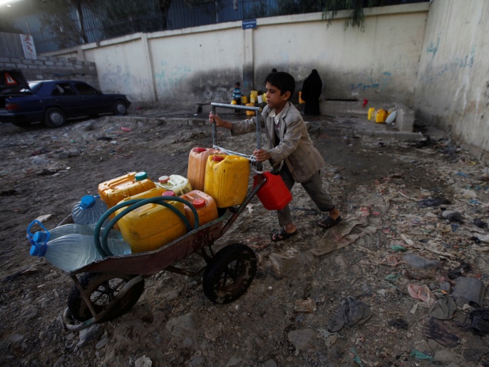 8b0baf27-c2ea-4e80-bbbf-41f21db94f48 A boy pushes a wheelbarrow filled with water containers after collecting drinking water from a charity tap, amid a cholera outbreak, in Sanaa, Yemen October 13, 2017. REUTERS/Mohamed al-Sayaghi?