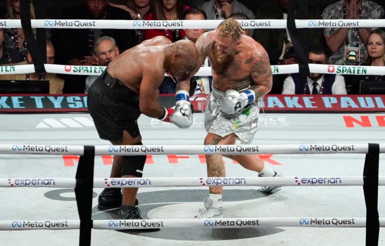 US retired pro-boxer Mike Tyson (L) and US YouTuber/boxer Jake Paul (R) fight during the heavyweight boxing bout at The Pavilion at AT&T Stadium in Arlington, Texas, November 15, 2024. (Photo by TIMOTHY A. CLARY / AFP)