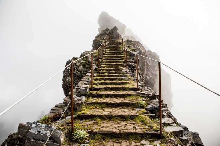 gettyimages-166617405-1732108731 Stairs on a highland trail in the mist. In the mountainous area of Pico do Arieiro, Madeira, Portugal