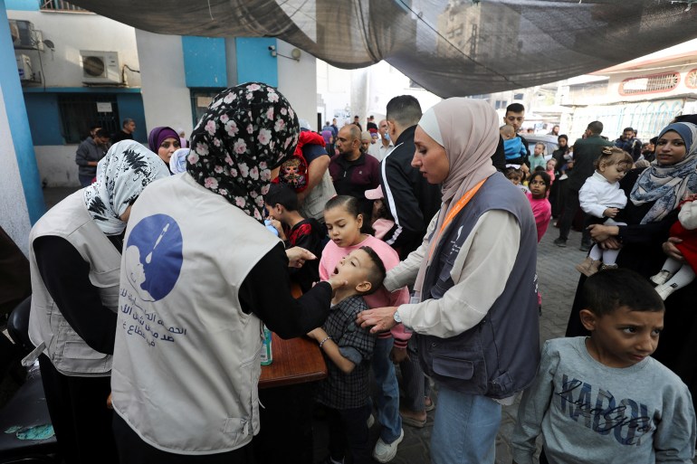 Palestinian children are vaccinated against polio during the second round of a vaccination campaign, amid the Israel-Hamas conflict, in Gaza City, November 2, 2024. REUTERS/Dawoud Abu Alkas