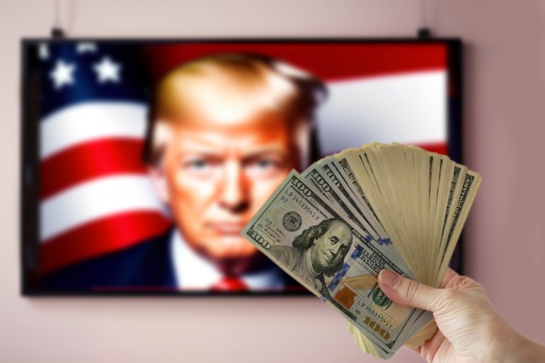 shutterstock_2518625675-1731606367 Washington, USA - September 16 2024: hand holding pile of money cash on Donald Trump portrait on TV background. US election 2024.