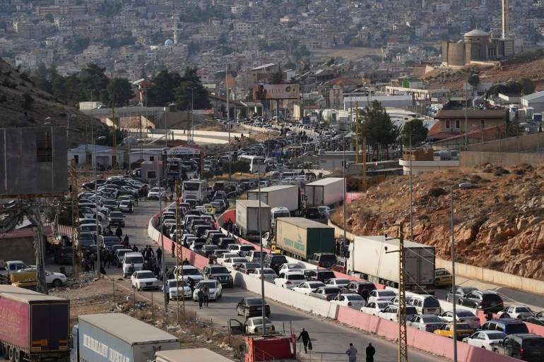 der-1733813571 People make their way as they attempt to cross into Lebanon at the Masnaa border crossing between the Lebanon and Syria, after Syrian rebels announced that they have ousted Syria's Bashar al-Assad, as pictured from the Syrian side December 9, 2024. REUTERS/Mohammed Yassin TPX IMAGES OF THE DAY