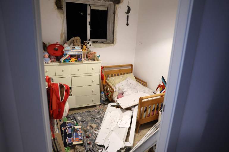 doc-36r328x-1734789357 This picture shows debris in a bedroom in Tel Aviv early on December 21, 2024, after a projectile fired from Yemen landed near the building. Israel's military said on December 21, it had failed to intercept a "projectile" launched from Yemen that landed in Tel Aviv, with the national medical service saying 16 people were lightly wounded. Yemen's Iranian-backed Huthi rebels have repeatedly launched missile attacks against Israel since the war in Gaza began more than a year ago, most of which have been intercepted. (Photo by Jack GUEZ / AFP)