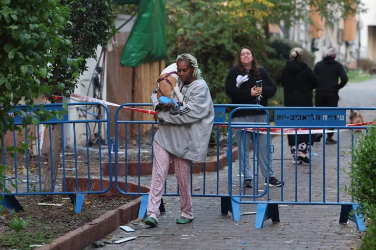 doc-36r39b2-1734789343 People evacuate their home in Tel Aviv early on December 21, 2024, after a projectile fired from Yemen landed near their building. Israel's military said on December 21, it had failed to intercept a "projectile" launched from Yemen that landed in Tel Aviv, with the national medical service saying 16 people were lightly wounded. Yemen's Iranian-backed Huthi rebels have repeatedly launched missile attacks against Israel since the war in Gaza began more than a year ago, most of which have been intercepted. (Photo by Jack GUEZ / AFP)