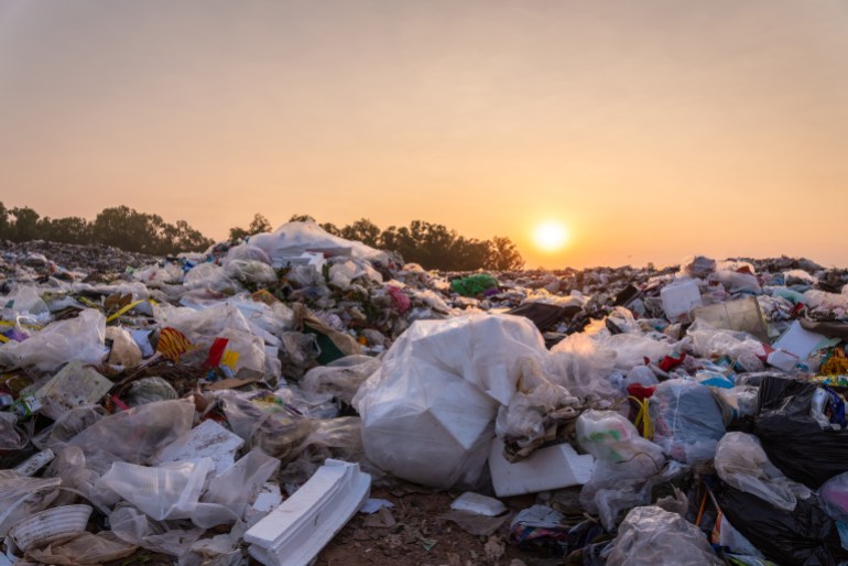 gettyimages-1300144187-1733145252 Close up large garbage pile near the sunset, global warming