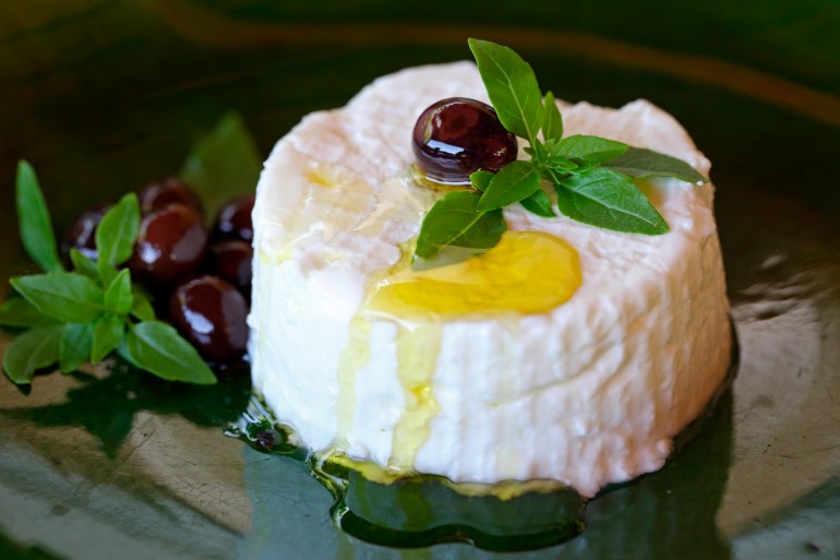 gettyimages-520686284-1733413444 Cream cheese from goat milk with olive oil, olives and fresh basil, Provence