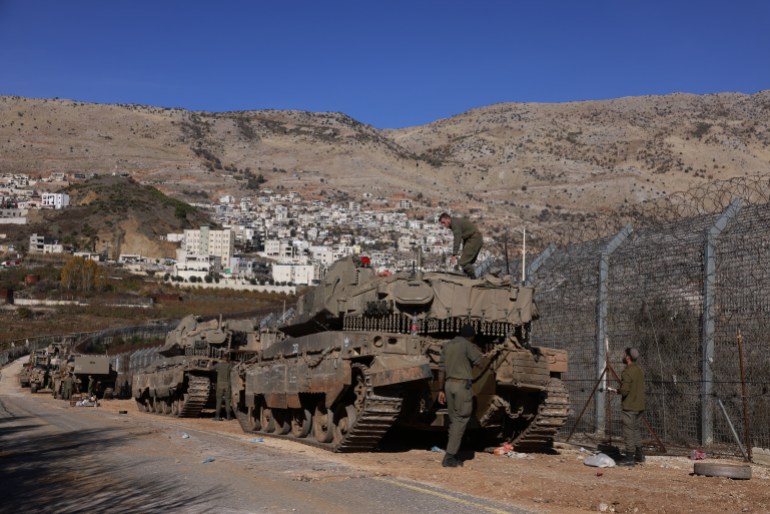 golan4-1733819271 Israeli Army tanks take position on outside the Druze village of Majdal Shams near the buffer zone that separates the Israeli-annexed Golan Heights from the rest of Syria on December 9, 2024. - Israel's Foreign Minister Gideon Saar said on December 9 that his country's military takeover of the buffer zone along its border with Syria was a "limited and temporary step" after Prime Minister Benjamin Netanyahu announced the previous day that he had ordered the army to "take control" of the zone, following the fall of Syrian president Bashar al-Assad. (Photo by Menahem Kahana / AFP)
