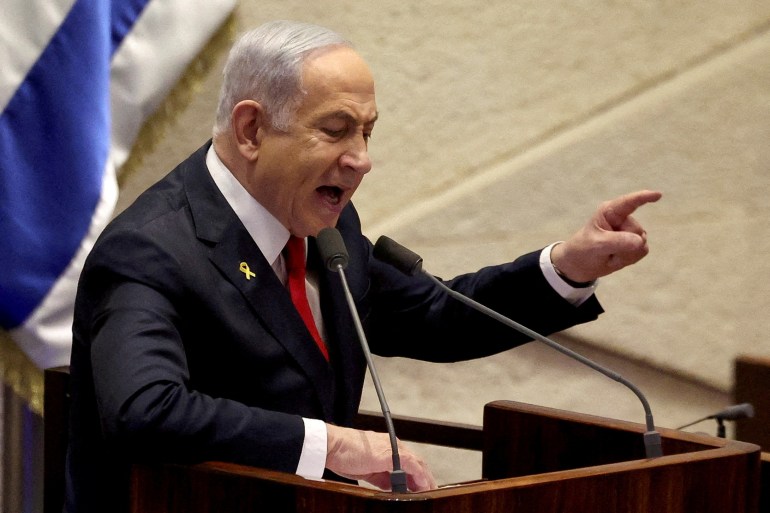 netanth658-1732877681-1 FILE PHOTO: Israeli Prime Minister Benjamin Netanyahu speaks at the plenum, during a discussion on the subject of hostages kidnapped during the deadly October 7, 2023 attack, in Israel's parliament, the Knesset, in Jerusalem, November 18, 2024. REUTERS/Ronen Zvulun//File Photo