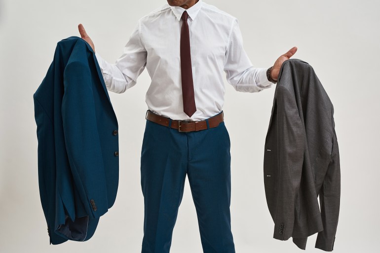 Cropped of black businessman or ceo manager choosing jacket. Adult man wearing formal wear and glasses. Concept of modern successful male lifestyle. Isolated on white background. Studio shoot; Shutterstock ID 2162391321; purchase_order: aj; job: ; client: ; other: