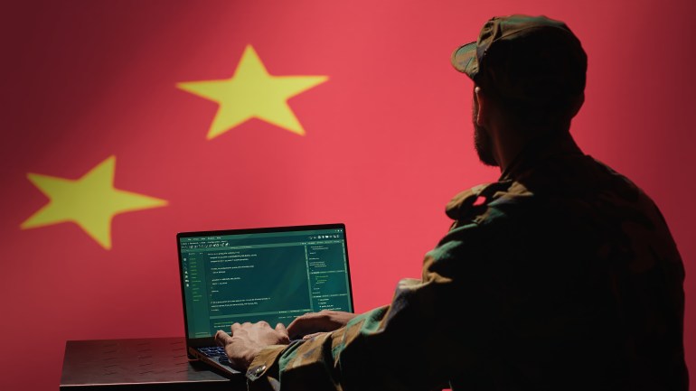 shutterstock_2481701511-1733131399 Chinese programmer making bot accounts on social networks promoting communist ideology. Technician working for CCP intelligence agency building algorithms to spread fake news