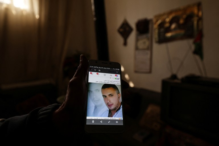 02-1736159857 Ibrahim Daraji, who said he is still mourning two sons, one disappeared into Sednaya prison and another lost to a mortar strike in Al-Yarmouk camp, shows a photo of his son Omar on his phone at his house at al-Yarmouk Palestinian refugee camp, after fighters of the ruling Syrian body ousted Bashar al-Assad, in Damascus, Syria December 20, 2024. REUTERS/Zohra Bensemra