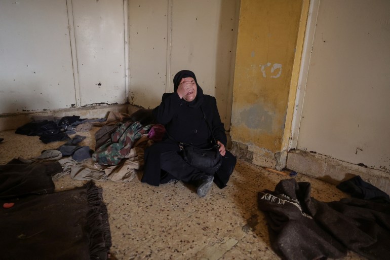 49-13-1736159960 Ibtissam Al-Nadaf who said she is still mourning two sons, one killed by a sniper during the siege of Al-Assali, the other disappeared into Sednaya prison in 2018, reacts as she hopes for any sign of her son as she sits inside a cell at the Sednaya prison, which was known as a slaughterhouse under Syria's Bashar al-Assad rule, after fighters of the ruling Syrian body ousted Bashar al-Assad, in Sednaya, Syria December 24, 2024. REUTERS/Zohra Bensemra