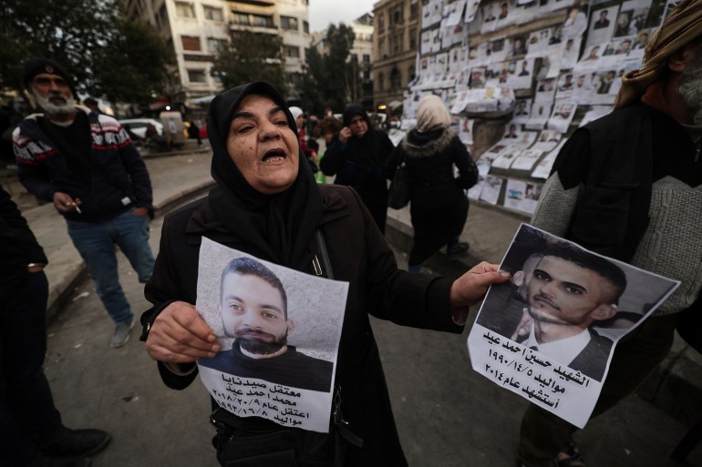 49-8-1736158894 Ibtissam Al-Nadaf who said she is still mourning two sons, one killed by a sniper during the siege of Al-Assali, the other disappeared into Sednaya prison in 2018, reacts as she holds her sons photographs at Marjeh Square also known as Martyrs Square in Damascus, Syria, December 22, 2024. REUTERS/Zohra Bensemra