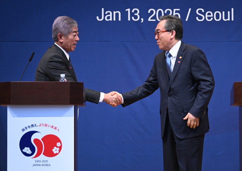 d8a8d98ad8ab4-1-1736763947 South Korean Foreign Minister Cho Tae-yul (R) shakes hands with Japanese Foreign Minister Takeshi Iwaya (L) after a joint press conference following their meeting at the Foreign Ministry in Seoul on January 13, 2025. (Photo by JUNG YEON-JE / POOL / AFP)