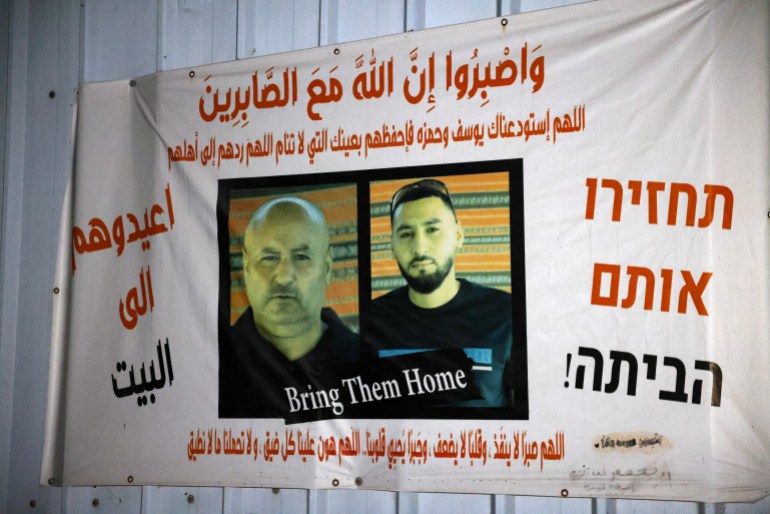 d8b1d8b1-1736510306 A banner bearing pictures of Bedouin Arab hostages Youssef al-Zayadna (L) and his son Hamza, hand at the gate of the family home in the southern bedouin city of Rahat, on January 8, 2025. The Bedouin Arab father and son were seized by Palestinian militants from Kibbutz Holit near the Gaza border during the Hamas attack of October 7, 2023. The Israeli military said on January 8 that its troops had recovered the body of Zayadna in Gaza and brought it back to Israel following a "complex and difficult operation" and that the son Hamza's body had not been recovered, although "findings were located related to Hamza... which raise serious concerns for his life". (Photo by AHMAD GHARABLI / AFP)