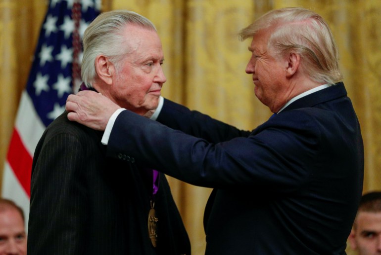 U.S. President Donald Trump presents a National Medal of Arts to actor Jon Voight during a ceremony to award the National Medal of Arts and National Humanities Medals in the East Room of the White House in Washington, U.S., November 21, 2019. REUTERS/Tom Brenner