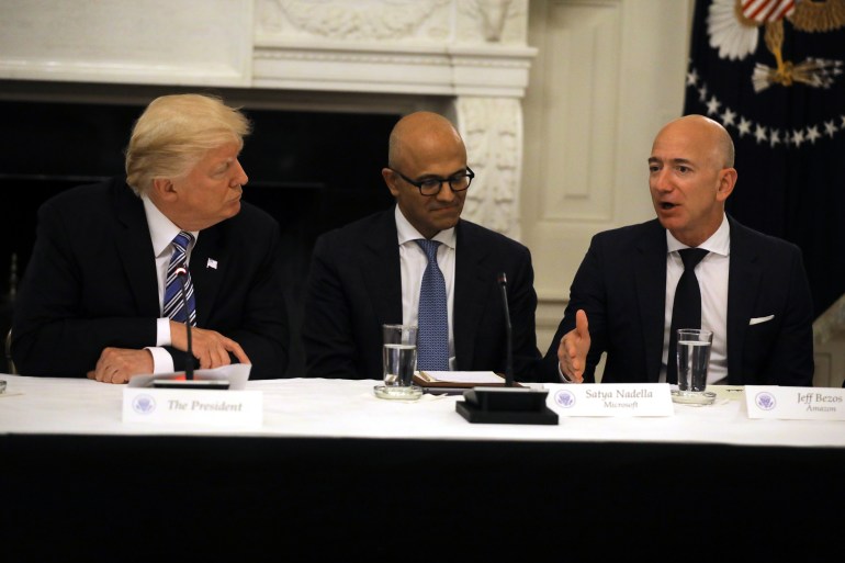 picture-7464441-1736181909 U.S. President Donald Trump and Satya Nadella, CEO of Microsoft Corporation listen as Jeff Bezos, CEO of Amazon speaks during an American Technology Council roundtable at the White House in Washington, U.S., June 19, 2017. REUTERS/Carlos Barria