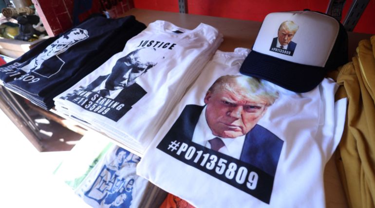 rc2yv2aehsvc-1693119559 T-shirts and hats with an image depicting the mugshot of former U.S President Donald Trump are pictured after being printed at the Y-Que printing store in Los Angeles