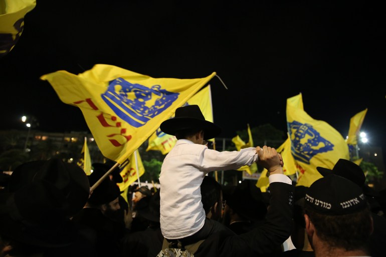 shutterstock_1124227733-1736678473 TEL AVIV, ISRAEL - JUNE 25, 2018: Unidentified Jewish men of the "Lubavitch-Chabad" sect of hasidim, dance and sing in parade celebrating the Messiah in Tel Aviv, Israel; Shutterstock ID 1124227733; purchase_order: aj; job: ; client: ; other: