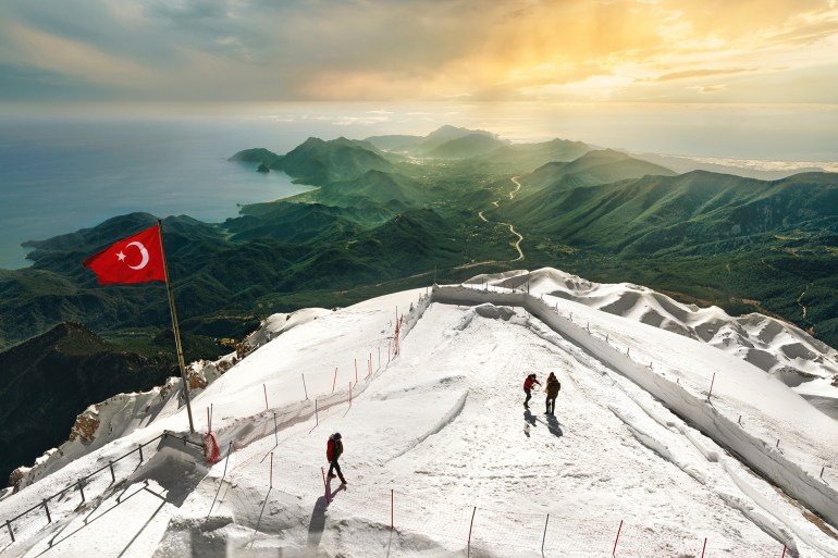 Snowy Tahtali mountain summit near Antalya Turkey with stunning green valley green and amazing shoreline.; Shutterstock ID 2123177120; purchase_order: aj; job: ; client: ; other: