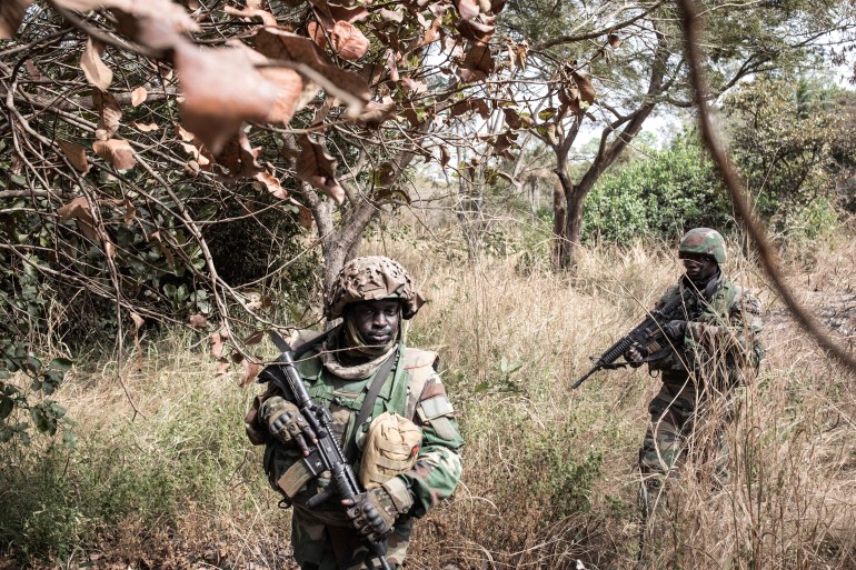 000_92l88m Members of the Senegalese Armed Forces take up position outside a recently captured Movement of Democratic Forces of Casamance (MFDC) rebel base in Blaze Forest on February 9, 2021. - The conflict in Casamance, which is separated from the rest of Senegal by The Gambia, has claimed thousands of lives since it first broke out in 1982. The army launched an operation on January 26, 2021 to "secure" the region and took hold of several bases from the MFDC rebels, including one of their main and historical bases in the Blaze Forest. (Photo by JOHN WESSELS / AFP)