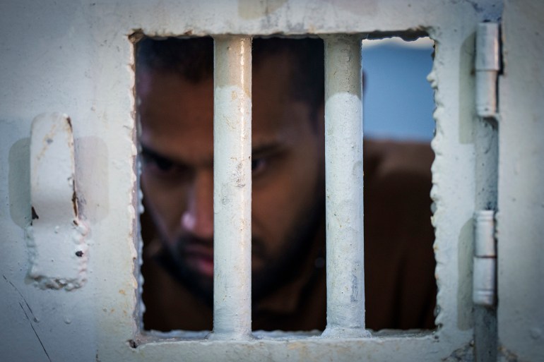 An inmate accused of being an Islamic State (ISIS) fighter stands inside a cell at the Syrian Democratic Forces-run Gweiran Prison, now called Panorama, in Hassakeh, northeastern Syria, Friday, Jan. 31, 2025. (AP Photo/Bernat Armangue)