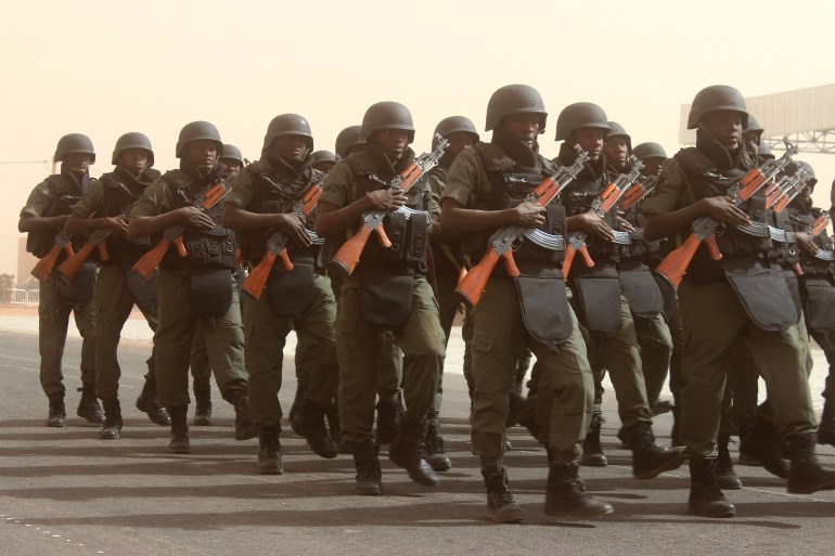 gettyimages-630215682-1711035725 AGADEZ, NIGER - DECEMBER 18: Soldiers parade during a ceremony marking the 58th anniversary of proclamation of the republic in Agadez, Niger on December 18, 2016. (Photo by Balima Boureima/Anadolu Agency/Getty Images)