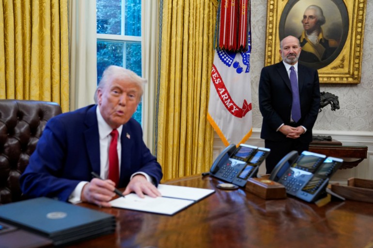 trump1-1738608560 U.S President Donald Trump signs a document as Howard Lutnick stands near him, at the White House, in Washington, U.S. February 3, 2025. REUTERS/Elizabeth Frantz
