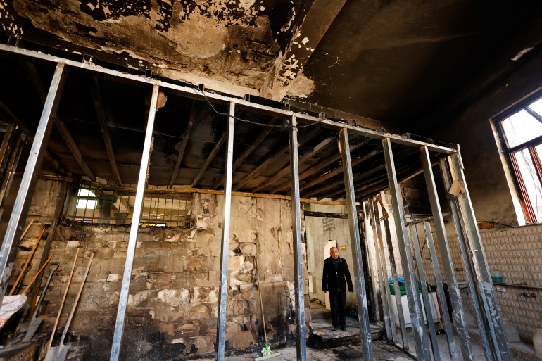 09-7-1741510545 A Palestinian man stands in a mosque a day after Israeli army set fire at the Al-Nasser mosque in Nablus, amid West Bank raids, March 8, 2025. REUTERS/Raneen Sawafta