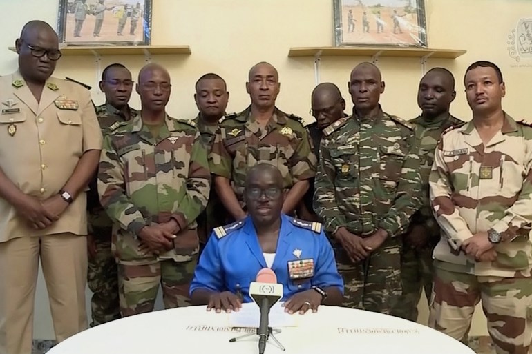 123340-1690426235 عسكريون في النيجر يعلنون عزل الرئيس محمد بازوم Niger Army spokesman Colonel Major Amadou Adramane speaks during an appearance on national television, after President Mohamed Bazoum was held in the presidential palace, in Niamey, Niger, July 26, 2023 in this still image taken from video. ORTN/via Reuters TV/Handout via REUTERS THIS IMAGE HAS BEEN SUPPLIED BY A THIRD PARTY. NO RESALES. NO ARCHIVES. NIGER OUT. NO COMMERCIAL OR EDITORIAL SALES IN NIGER