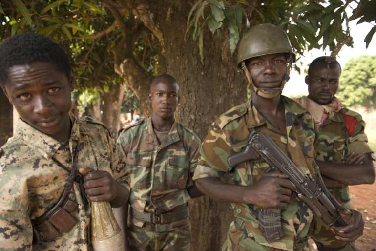 3-3-1719925660 Soldiers from the Central African Republic National Army (ex-Seleka) pose at the PK 11 district, northern Bangui on December 30, 2013. More than 1,000 people are believed to have been killed in three weeks of sectarian violence in Bangui alone. AFP PHOTO / MIGUEL MEDINA (Photo by MIGUEL MEDINA / AFP)