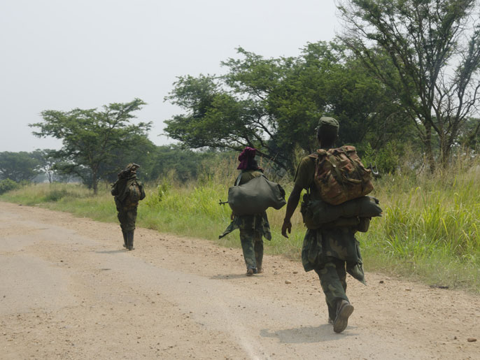 a6a93f21-bb13-4a68-b065-00fcf4ea63ec soldiers walk on their way to Rwindi on July 9, 2012. Congolese mutineers on July 9, 2012 pulled out of the key eastern town of Rutshuru, near the borders with Uganda and Rwanda, a day after seizing it. The M23 movement -- a group of former Tutsi rebels who had been integrated in the regular army in 2009 -- has been battling Democratic Republic of Congo troops since May. In recent days, the rebels had seized several towns in the troubled Nord Kivu province, including Rutshuru, which lies some 20 kilometres (12 miles) from the Ugandan border, half-way between Lake Edward and Lake Kivu. AFP