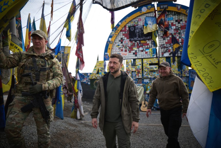 afp-1871763163_1b9def-1742700118 This handout photograph taken and released by Ukrainian Presidential Press Service on March 22, 2025, shows Ukraine's President Volodymyr Zelensky (C) visiting the site indicating the entrance to the Donetsk region, amid the Russian invasion of Ukraine.