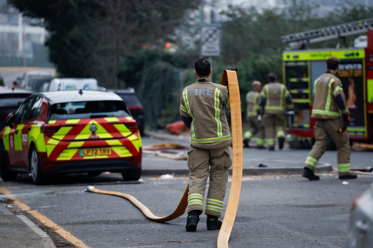 aire-1742550576 A firefighter helps putting out a fire that broke out at a substation supplying power to Heathrow Airport in Hayes, west London on March 21, 2025. Britain's Heathrow airport, Europe's busiest, was shut down early on March 21 for 24 hours after a major fire at an electricity substation cut power to the sprawling facility west of London, officials said. (Photo by BENJAMIN CREMEL / AFP)