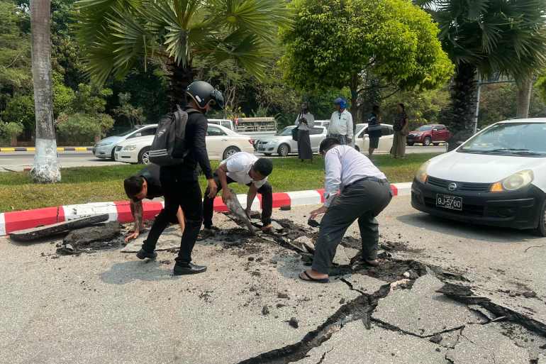 doc-388j3fu-1743147688 Motorists pick up pieces of a damaged road in Naypyidaw on March 28, 2025, after an earthquake in central Myanmar. A powerful earthquake rocked central Myanmar on March 28, buckling roads in capital Naypyidaw, damaging buildings and forcing people to flee into the streets in neighbouring Thailand. (Photo by AFP)