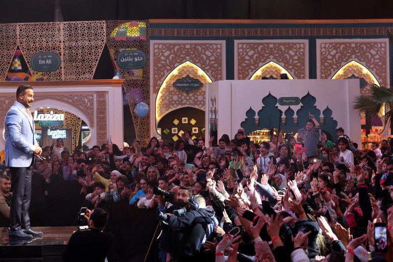 Lebanese actor Wissam Hanna addresses the crowd during the taping of the ìAkram Men Minî program, which airs on the LBCI channel during the Muslim holy fasting month of Ramadan, in Beirut on March 21, 2025. (Photo by ANWAR AMRO / AFP)