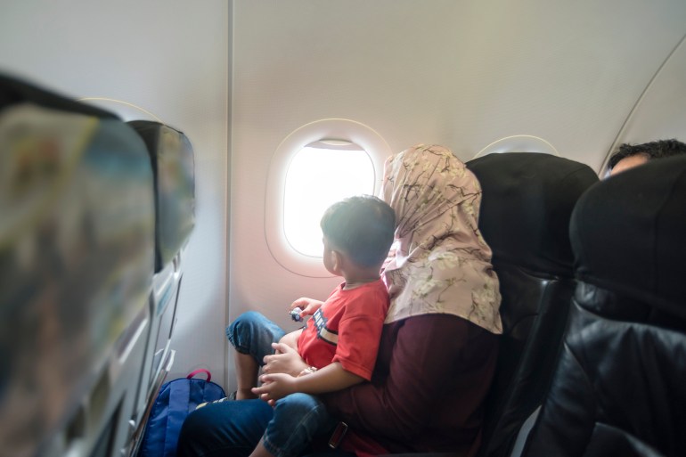 Mother and son in a plane - stock photo