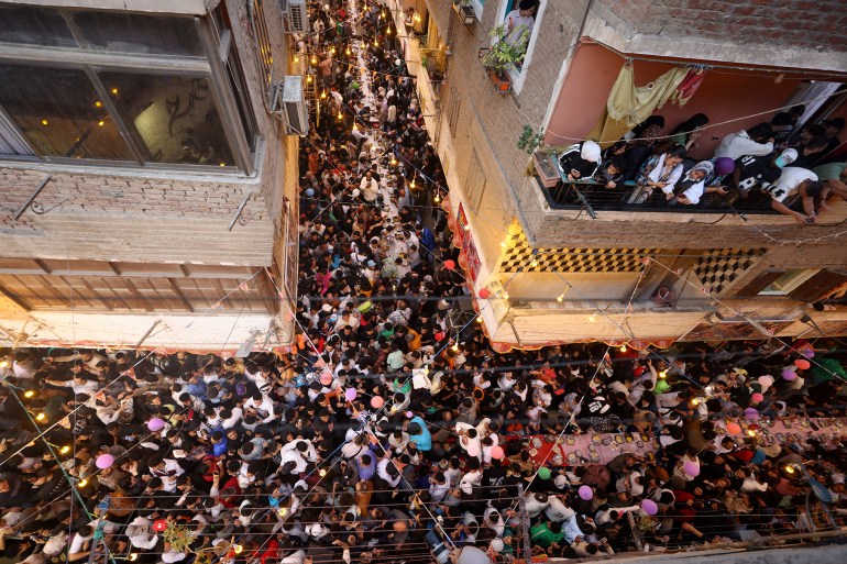 iftar-egy3-1742068394 Egyptian residents of Ezbet Hamada in Cairo's Mataria district gather to eat Iftar, the meal to end their fast at sunset, during the holy fasting month of Ramadan in Cairo, Egypt March 15, 2025. REUTERS/Mohamed Abd El Ghany