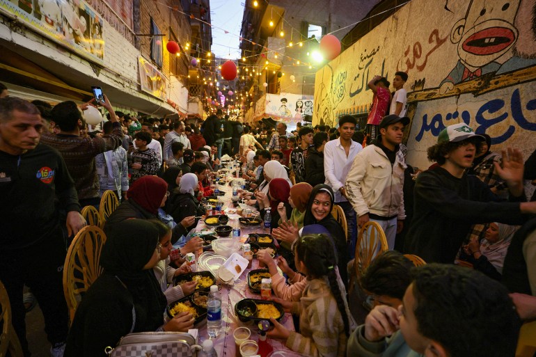 iftar-egy8-1742068447 Egyptian residents of Ezbet Hamada in Cairo's Mataria district gather to eat Iftar, the meal to end their fast at sunset, during the holy fasting month of Ramadan in Cairo, Egypt March 15, 2025. REUTERS/Mohamed Abd El Ghany