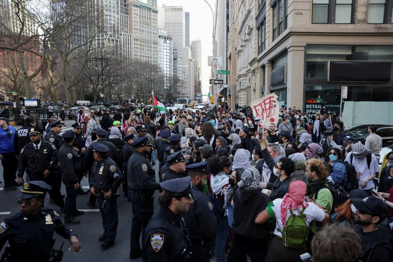 Police officers stand guard as demonstrators attend a protest near the City Hall, following the arrest by US immigration agents of Palestinian student protester Mahmoud Khalil at Columbia University in New York City, U.S., March 11, 2025. REUTERS/Jeenah Moon