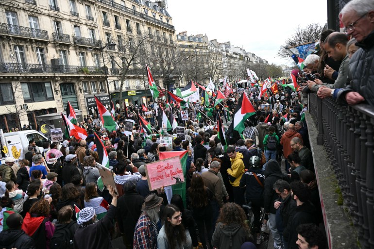 paris1-1742729122 Protestors wave Palestinian flags during a demonstration on Place de la Republique in Paris on March 22, 2025, as part of the international day against racism and fascism. (Photo by Bertrand GUAY / AFP)