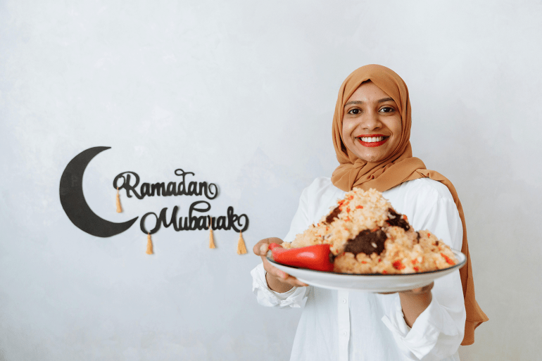 pic-888442-1742232645 Woman in Brown Hijab Holding a Plate with Food