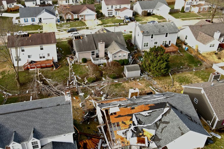 reuters-806959658_2f4c04-1742070051 Debris lies around damaged houses the morning after a tornado touched down in Florissant, Missouri, U.S. March 15, 2025. REUTERS/Lawrence Bryant